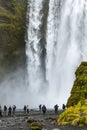 Tourists near Skogafoss waterfall in Iceland Royalty Free Stock Photo