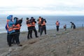 Tourists observe Magellanic penguins on Magdalena island in the Strait of Magellan near Punta Arenas. Royalty Free Stock Photo