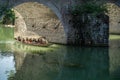 Tourists in old wooden boat in Fenghuang