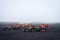 In orange overalls on quad bikes near the Abandoned wreck of DC Plane