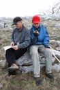 Tourists orienteering by map and GPS.