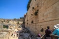 Tourists overlook a Herodian street below Robinson`s Arch, an unusually wide stone arch, which once stood at the southwestern