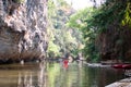 Tourists are Paddle Kayak boat and The boat made of bamboo In the river