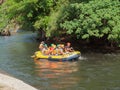 Tourists paddle whitewater river in Garden.