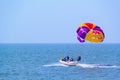 Tourists parasailing on Candolim Beach in Goa, India.