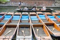 Tourists pass a row of punts Royalty Free Stock Photo