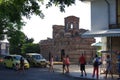 Tourists passing by Eastern Orthodox church in Bulgarian Nesebar