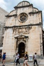 Tourists passing by Church of Saint Saviour`s front door in Dubr Royalty Free Stock Photo