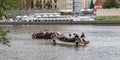 Tourists on pedal boats glide on the Vltava river in Prague