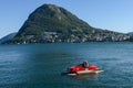 Tourists pedaling in a pedal boat on lake of Lugano