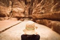 Tourists in Petra take photograph of The Siq, the narrow slot-canyon that serves as the entrance passage to the hidden city of