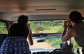 Tourists photograph an antelope out of a safari jeep. South Africa.