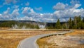 Tourists photograph a hot spring in Yellowstone National Park