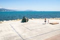 Tourists photograph sculpture Horse and Dolphin