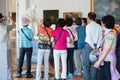 Tourists photograph statue of Voltaire in Hermitage