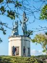 Tourists photographing and admiring Balinese statues