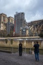 Tourists photographing the Notre-Dame construction site in Paris, France Royalty Free Stock Photo