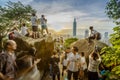 Tourists photographing Taipei 101 at sunset