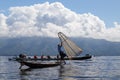 Tourists photographing traditional Burmese fisherman posing for them at Inle lake. Myanmar Burma. Royalty Free Stock Photo