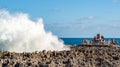 Tourists photographing waves hitting the reef