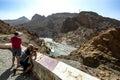 Tourists photographing the Ziz Rver in the Ziz Valley in the High Atlas Mountains of Morocco.