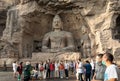 Tourists photography in front of iconic seated Buddha statue