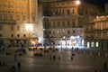 Tourists in Piazza del Campo by night, Siena, Italy. The historic centre of Siena. UNESCO World Heritage Site