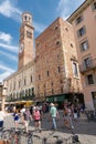 Piazza delle Erbe with the Torre dei Lamberti bell tower in the old town of Verona in Italy Royalty Free Stock Photo