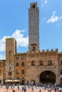 Tourists at the piazza duomo in San Gimignano, Italy