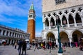 Tourists at the Piazza San Marco with St. Mark`s Campanile, The Lion of Venice and Doge`s Palace Palazzo Ducale in Venice Italy Royalty Free Stock Photo