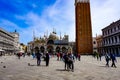 Tourists at the Piazza San Marco with St. Mark`s Campanile, The Lion of Venice and Doge`s Palace Palazzo Ducale in Venice Italy Royalty Free Stock Photo