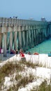 Tourists by a pier on the beach