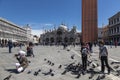 Tourists and pigeons in Piazza San Marco in Venice,