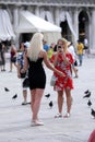 Tourists and pigeons in Venice, Italy Royalty Free Stock Photo