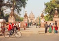 Tourists, pilgrims and cyclists going past famous old Buddhist temple