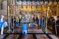 Tourists and pilgrims are playing Stone of Anointing or Stone of Unction, the spot where Jesus' body was prepared for burial by