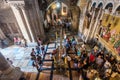 Tourists and pilgrims are playing Stone of Anointing or Stone of Unction, the spot where Jesus' body was prepared for burial by