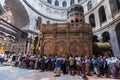 Tourists and pilgrims stand in line waiting to enter Jesus's empty tomb, where he is said to have been buried and resurrected in