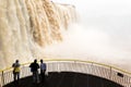 Tourists in a platform at iguazu falls veiw from brazil