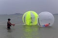 Tourists playing water walking ball at the seaside of dongshan island