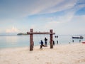 Tourists playing wooden swing with white sand beach sea view background, Travel plans in holidays or after retirement