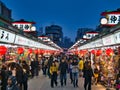 Tourists in the popular Nakamise Shopping Street near the Senso-ji Temple, Tokyo, Japan