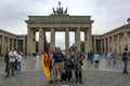 Tourists pose for photographs in front of the The Brandenburg Gate in Berlin in Germany.