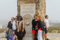 Tourists pose for a picture next to the monument declaring Cabo da Roca as the most western point of continental Europe Royalty Free Stock Photo