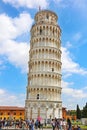 Tourists posing in front of the leaning Pisa tower in Italy - one of the most famous italian landmarks