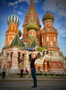 Tourists posing by the Saint Basil`s Cathedral in Moscow, Russa.