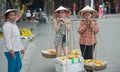 Tourists posing with vendors, Hoi An, Vietnam