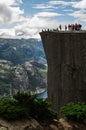 Tourists on Preikestolen cliff in Norway, Lysefjord view