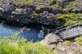 Tourists prepare to snorkel between the two tectonic plates at the steps to