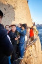 Tourists queue on the Plank Walk in the Sky, worlds most dangerous hike.